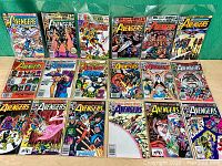 Group photo showing 18 The Avengers comic issues laid out on green background.