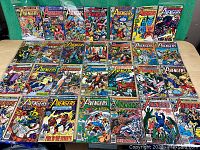 Front view of 28 issues of The Avengers comics laid out in rows showing cover art and titles.