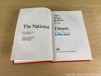 Open book displaying the title page and signature of Pierre Berton.