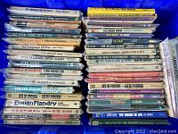 Image showing two stacks of vintage science fiction and pulp paperback books arranged spine-out on a blue background.