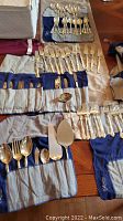 Overview of flatware pieces laid out in fabric rolls