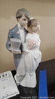 Front view of the bride and groom figurine showing attire and details