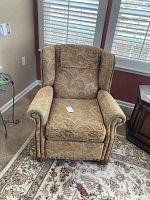 Front view of the Norwalk furniture recliner chair showing patterned fabric upholstery and studded detailing on arms.