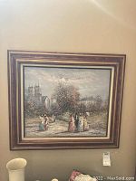 Framed original painting showing women in period dress with architectural buildings and trees in background.