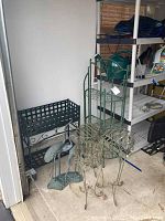 Overview of the set showing plant stands, metal shelving, and yard herons in garage environment.