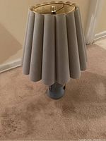 Top view of the blue ceramic lamp base with pleated shade showing shape and fabric condition