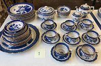 Full overview of all china pieces arranged on table.