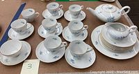 Full set of KPM Krister china with cups, saucers, bread plates, creamer and dinner plate.