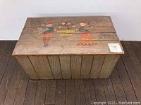 Top-down view of wooden chest showing folk art painting and overall condition from above.