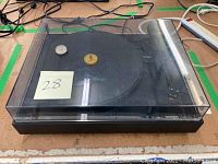 Front view of turntable with clear dust cover closed showing overall condition
