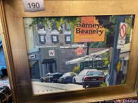 Overall view of the street scene painting in its painted gold frame showing Barney's Beanery sign, buildings, and cars.