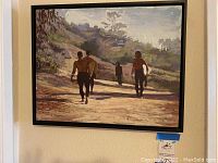 Full view of framed painting showing three surfers walking on a beach path with natural landscape background