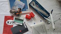 Overview of items showing the ExpressJet model airplane and various airline documents spread on a flat surface