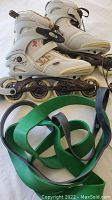 Photo of white size 8 women's rollerblades with green and black resistance bands