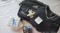Overview of ExpressJet Airlines flight attendant shirt, bag, seat belt demo set, hot washcloths, and airplane figurine