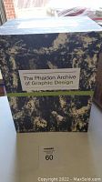 Photo of the boxed set with textured blue and cream design and green stripe, titled The Phaidon Archive of Graphic Design.