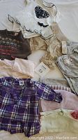 Overview of assorted baby girl clothes from 0-3 months