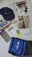 Overview of Continental Airlines memorabilia lot, including a cap, pins, luggage tag, promotional items, and small vials