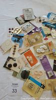 Top down view showing assortment of vintage buttons with various packaging including Dritz Battons & Covers and Westex brand packaging