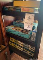 Shelving unit with multiple boxed HO scale train kits