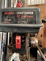 Close-up image of Sears Craftsman 10" drill press showing brand label, motor specs, and power switch.