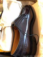 Men's Florsheim dark brown polished leather dress shoes size 12 with brogue detailing.