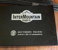 Black InterMountain Railway Co. box lid reading “Southern Pacific 4-8-8-2 AC-12 Locomotive”
