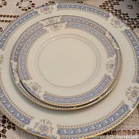 Stack of three plate sizes showing pattern and gold rim