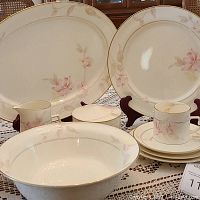 Group shot showing 14" oval platters, serving bowls, cup, saucer, sugar bowl and creamer on tablecloth
