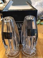 Pair of clear crystal Mikasa salt and pepper shakers with labels and original box visible