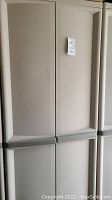 Full front view of tall white Sterilite storage cabinet with four doors, closed.