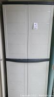 Front view of the beige Sterilite storage cabinet with black handles showing double doors.