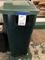 Green Rubbermaid 30 gallon garbage can with hinged lid, closed