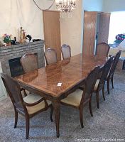 Angled shot of wood dining table with matching chairs in room