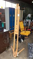 Full view of the wooden Winsor & Newton artist easel standing upright showing the frame and leg structure.
