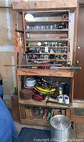 Photos of wooden shelves containing various glass jars, hand tools, and miscellaneous garage items.
