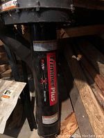 Close-up of Troy Bilt string trimmer shaft with branding and model number 887201