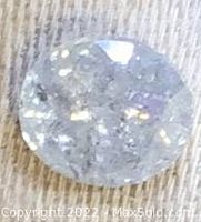 Top-down view of loose diamond on fabric background showing table facets
