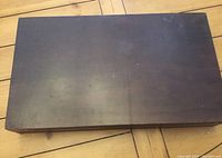 Closed wooden box containing flatware set.