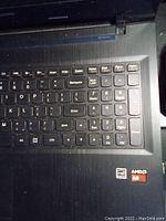 Close-up showing keyboard of Lenovo ThinkPad laptop with AMD A8 sticker and numeric keypad.