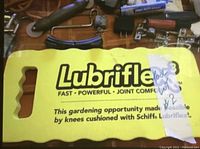 Close-up photo of a yellow Lubriflex kneeling pad with handle openings and printed branding