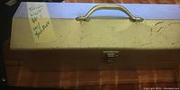 Closed metal toolbox with handle and label reading 'Tool Lot 4x w/ Toolbox'