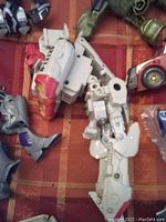 Close-up of white and red robot arm and mechanical parts.