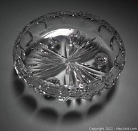 Top view of clear glass bowl showing starburst base pattern and circular cut designs
