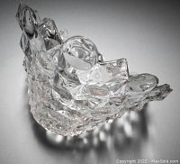 Angled side view showing the scalloped rim edge and textured geometric pattern on the clear glass bowl.