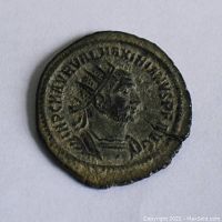 Obverse side of the ancient Roman coin showing emperor's right-facing bust with radiate crown and inscriptions.