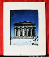 Front view of the photographic print showing the ancient Greek temple with Doric columns and blue sky background, mounted on white mat board.