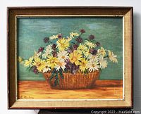 Full view of framed floral print showing basket of yellow and white daisies with purple flowers against a green-blue background, signed E. Mulan in lower left.