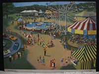 Image of one side of the card showing a colorful fairground with attractions like Ferris wheel, boats, carousel, and many people.