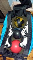Top view showing the three bowling balls and men's bowling shoes inside the carrying bag